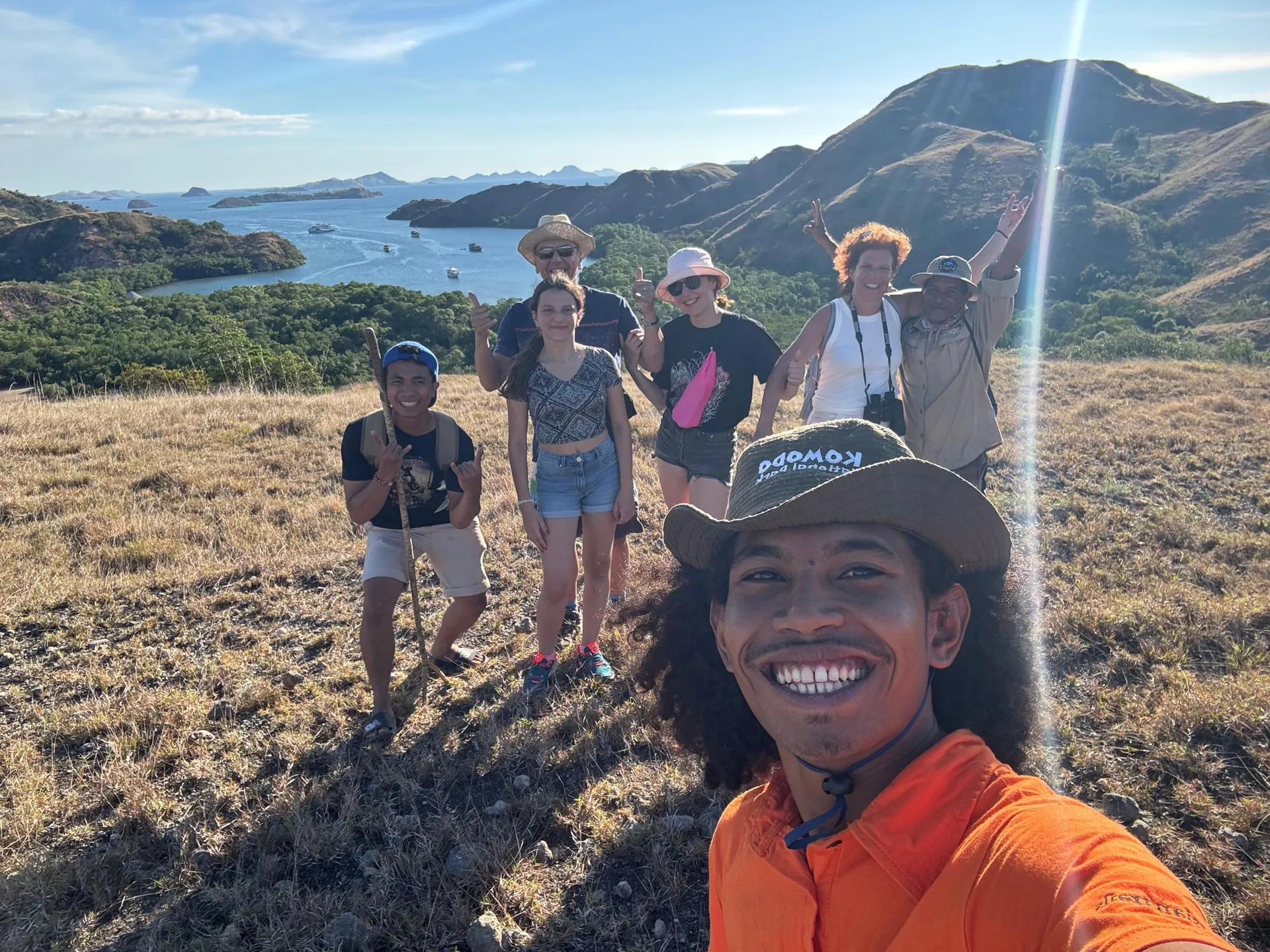 Travellers at a hilltop viewpoint over Padar Island