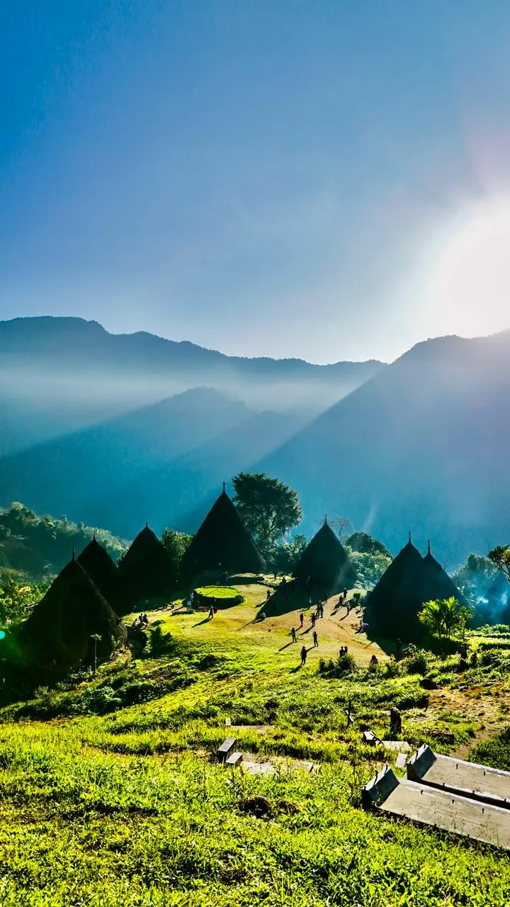 Sunbeams over the traditional cone houses of Wae Rebo village